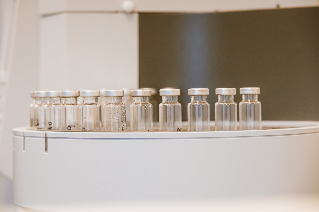 Close-up of empty glass vials arranged in a laboratory environment.